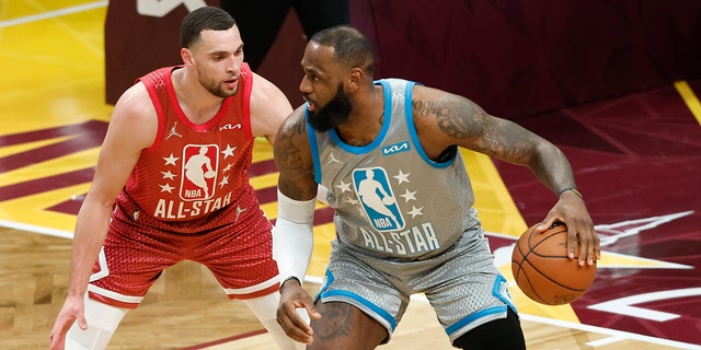 The Los Angeles Lakers' LeBron James looks to score as the Chicago Bulls' Zach LaVine defends during the second half of the NBA All-Star basketball game, Sunday, Feb. 20, 2022, in Cleveland.
