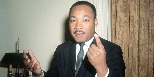 FILE – PA News Photo 25/9/64 : Dr. Martin Luther King, the American Black leader gestures as he carries on an animated conversation during a one-day visit to London in connection with the publication of the British version of his latest book on the Civil Rights issue "Why We Can't Wait"  