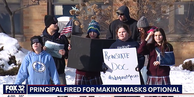 Parents and students held signs reading "Reinstate Doc" and "No More Masks."