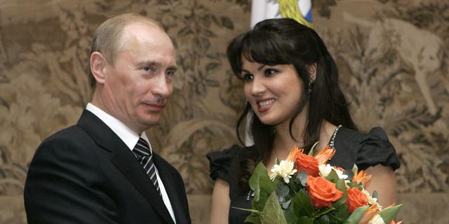 Russian President Vladimir Putin congratulates Anna Netrebko after awarding her with the People's Artist of Russia honor in St. Petersburg, Russia, on Feb. 27, 2008.