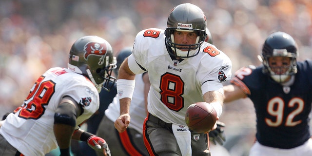 Tampa Bay Buccaneers quarterback Brian Griese hands off to Warrick Dunn during the quarter second of an NFL football game against the Chicago Bears, Sunday, Sept. 21, 2008, in Chicago. 