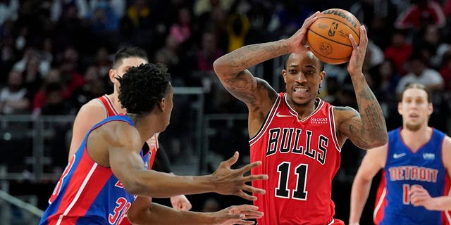 Chicago Bulls forward DeMar DeRozan (11) looks to pass as Detroit Pistons guard Saben Lee (38) defends during the second half of an NBA basketball game, Wednesday, March 9, 2022, in Detroit.