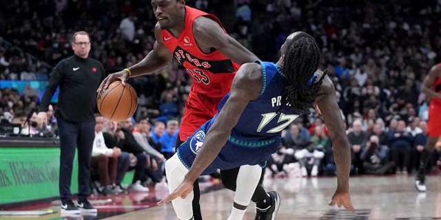 Toronto Raptors forward Pascal Siakam (43) runs into Minnesota Timberwolves forward Taurean Prince (12), sending him to the floor during the first half of an NBA basketball game Wednesday, March 30, 2022, in Toronto.