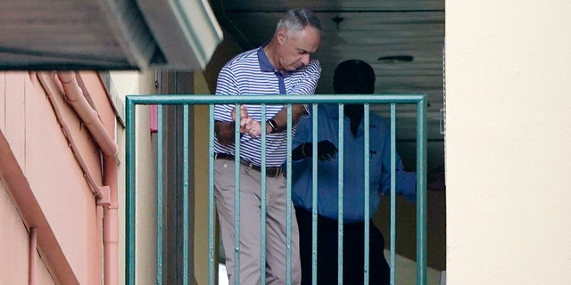 Major League Baseball Commissioner Rob Manfred practices his golf swing as negotiations continue with the players' association toward a labor deal, Tuesday, March 1, 2022, at Roger Dean Stadium in Jupiter, Florida.