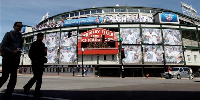 April 4, 2012: People walk by the Marquee at Wrigley Field