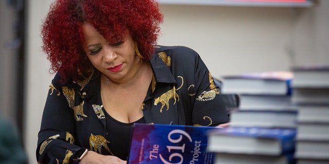 Pulitzer Prize-winning investigative journalist Nikole Hannah-Jones signs books for her supporters before taking the stage to discuss her new book, The 1619 Project.
