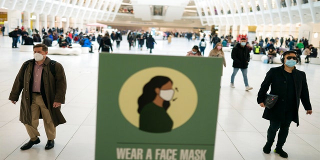 Mass transit riders wear masks as they commute in the financial district of lower Manhattan, Tuesday, April 19, 2022, in New York. 