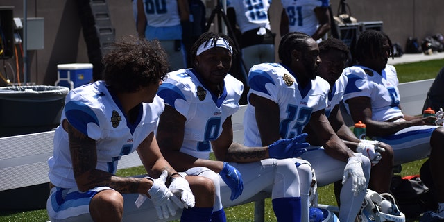 New Orleans Breakers players on the sideline during a scrimmage.