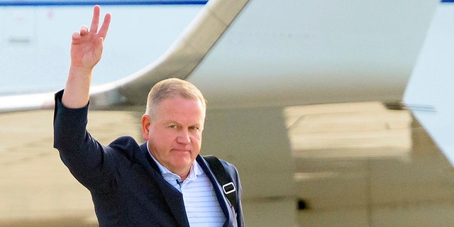 New LSU football coach Brian Kelly gestures to fans after his arrival at Baton Rouge Metropolitan Airport, Tuesday, Nov. 30, 2021, in Baton Rouge, La. Kelly, formerly of Notre Dame, is said to have agreed to a 10-year contract with LSU worth $95 million plus incentives.  