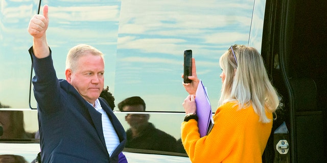 New LSU football coach Brian Kelly gestures to fans after his arrival at Baton Rouge Metropolitan Airport, Tuesday, Nov. 30, 2021, in Baton Rouge, La. Kelly, formerly of Notre Dame, is said to have agreed to a 10-year contract with LSU worth $95 million plus incentives. 