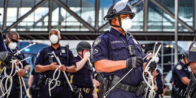 ATLANTA, USA - MAY 29: Police officers stand guard during a protest following the death of George Floyd outside of the CNN Center next to Centennial Olympic Park in downtown Atlanta, Georgia, United States on May 29, 2020. It was announced Friday that Derek Chauvin, the former Minneapolis police officer caught on camera with his knee on Floydâs neck, has been arrested and charged with third-degree murder and manslaughter. (Photo by Ben Hendren/Anadolu Agency via Getty Images)