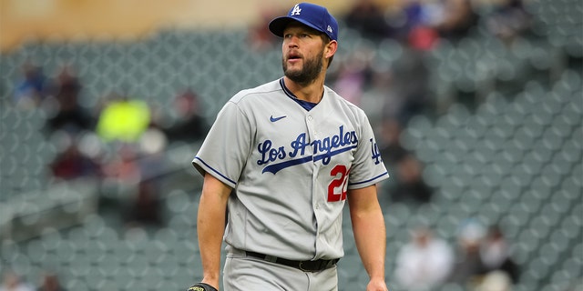 Clayton Kershaw of the Los Angeles Dodgers walks to the dugout after recording a strikeout against Nick Gordon of the Minnesota Twins to end the sixth inning at Target Field April 13, 2022, in Minneapolis. 