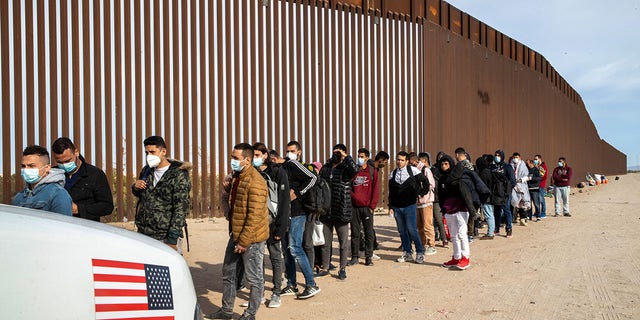 Immigrant men from many countries are taken into custody by U.S. Border Patrol agents at the U.S.-Mexico border on December 07, 2021 in Yuma, Arizona. Governors from 26 states have formed a strike force to address the crisis at the border.