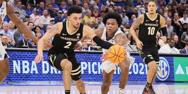 Sahvir Wheeler #2 of the Kentucky Wildcats and Scotty Pippen Jr. #2 of the Vanderbilt Commodores reach for a loose ball during the quarterfinals of the 2022 SEC Men's Basketball Tournament at Amalie Arena on March 11, 2022 in Tampa, Florida.