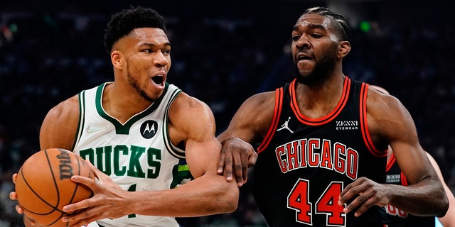 Milwaukee Bucks' Giannis Antetokounmpo tries to get past Chicago Bulls' Patrick Williams during the first half of Game 1 of their first round NBA playoff basketball game Sunday, April 17, 2022, in Milwaukee.