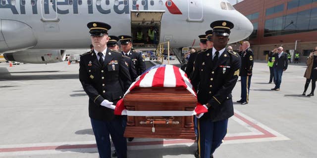 Honor Guard made up of members of the Utah National Guard conduct an Honorable Carry of Army Cpl. David B. Milano's remains at the Salt Lake City International Airport, April 26, 2022.