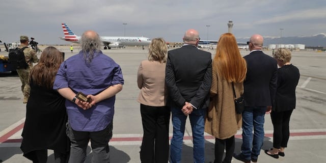 Surviving members of Army Cpl. David B. Milano's family await the arrival of his casket on the tarmac of Salt Lake City International Airport.