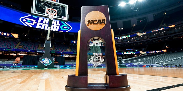 The men's basketball Division I national championship trophy is displayed on the court ahead of the Final Four during the NCAA men's basketball tournament at the Caesars Superdome March 31, 2022, in New Orleans.