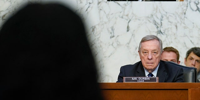 Sen. Dick Durbin, D-Ill., chairman of the Senate Judiciary Committee, listens as Supreme Court nominee Ketanji Brown speaks during her Senate Judiciary Committee confirmation hearing on Capitol Hill in Washington, Monday, March 21, 2022. (AP Photo/J. Scott Applewhite, Pool)