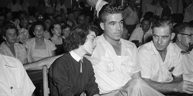 Carolyn Bryant rests her head on her husband Roy Bryant's shoulder after she testified in the Emmett Till murder case in Sumner, Mississippi, on Sept. 22, 1955.