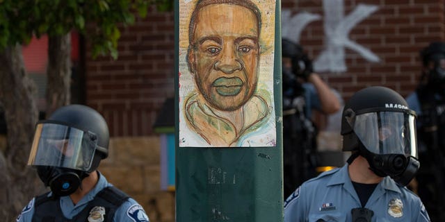 FILE - Minneapolis police stand outside the department's 3rd Precinct on May 27, 2020, in Minneapolis. 