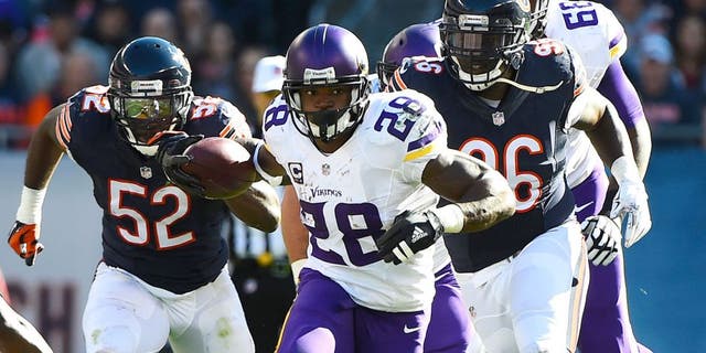 Nov 1, 2015; Chicago, IL, USA; Minnesota Vikings running back Adrian Peterson (28) carries the ball against the Chicago Bears during the first half at Soldier Field.