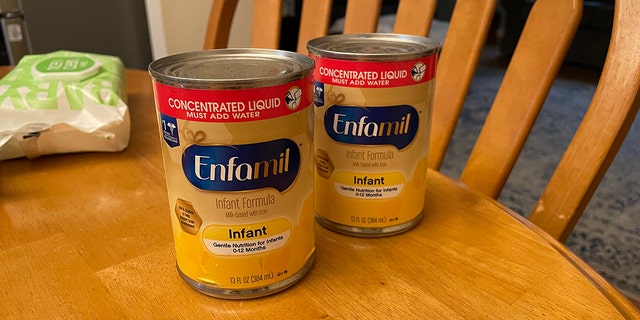 Two cans of baby formula are shown here in a home. The American Academy of Pediatrics (AAP) says parents should not hoard supplies. 
