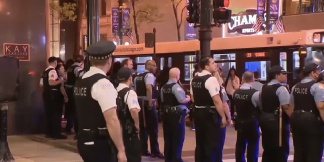Police line the streets of downtown Chicago after a 16-year-old boy was shot and killed in Millennium Park Saturday night May 14, 2022.