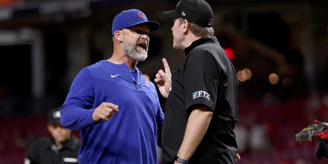 Manager David Ross of the Chicago Cubs and umpire Chris Conroy argue after Ross was ejected in the ninth inning against the Cincinnati Reds at Great American Ball Park May 25, 2022, in Cincinnati. 