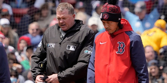 Home plate umpire Ron Kulpa leaves the game after being hit with a foul ball during the fourth inning of a game between the Boston Red Sox and the Chicago White Sox at Fenway Park, Sunday, May 8, 2022, in Boston. 