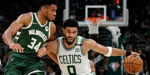 Boston Celtics' Jayson Tatum tries to get past Milwaukee Bucks' Giannis Antetokounmpo during the second half of Game 6 of an NBA basketball Eastern Conference semifinals playoff series Friday, May 13, 2022, in Milwaukee. The Celtics won 108-95 to tie the series at 3-3. 