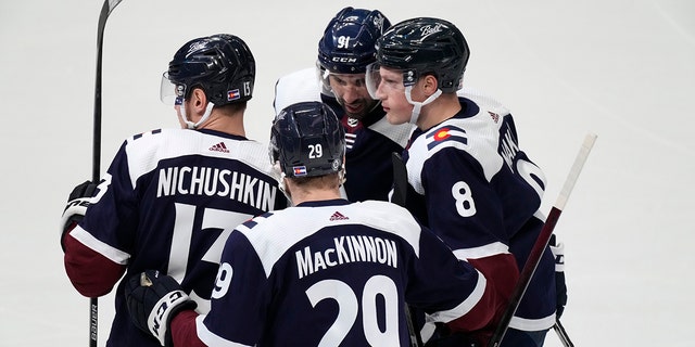 Colorado Avalanche defenseman Cale Makar, right, is congratulated by right wing Valeri Nichushkin, left, center Nathan MacKinnon, front center, and center Nazem Kadri for Makar's goal during the first period of an NHL hockey game against the Nashville Predators on Thursday, April 28, 2022, in Denver.