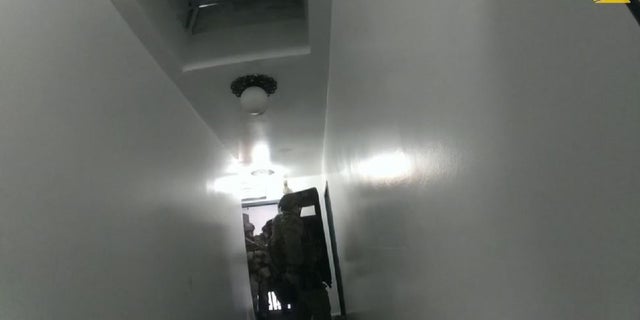 Chicago police SWAT members in a hallway.