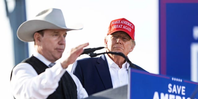 Republican gubernatorial candidate Charles Herbster speaks while former President Donald Trump stands by at a rally in Greenwood, Nebraska, on May 1, 2022. 