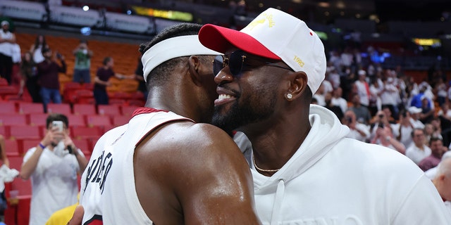 Jimmy Butler #22 of the Miami Heat hugs former Miami Heat player Dwyane Wade after Game Two of the Eastern Conference Semifinals against the Philadelphia 76ers at FTX Arena on May 04, 2022 in Miami, Florida.