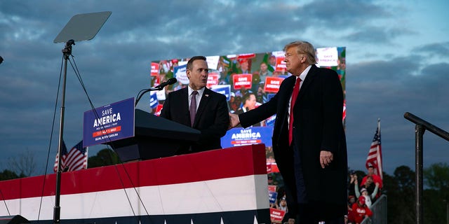 Rep. Ted Budd, who is running for the Senate, joins the stage with former President Donald Trump during a rally at The Farm at 95 on April 9, 2022 in Selma, North Carolina.  