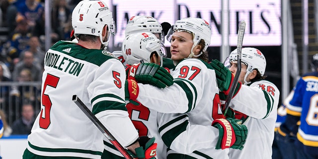 Minnesota players celebrate a goal during the Stanley Cup Playoffs between the Wild and the Blues on April 29, 2022, at the Enterprise Center in St. Louis, Missouri.