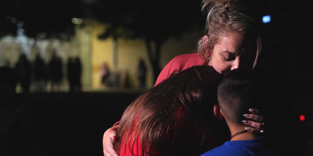 Families hug outside the Willie de Leon Civic Center where grief counseling is being offered in Uvalde, Texas. A teen gunman killed at least 19 children in a shooting at an elementary school in Texas on Tuesday, May 24, 2022.