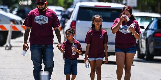 A victim's family walks out of the Robb Elementary School in Uvalde, Texas, on May 25, 2022.