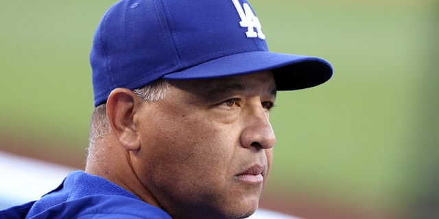 Manager Dave Roberts #30 of the Los Angeles Dodgers looks on in the dugout prior to game two of a doubleheader against the Arizona Diamondbacks at Dodger Stadium on May 17, 2022, in Los Angeles