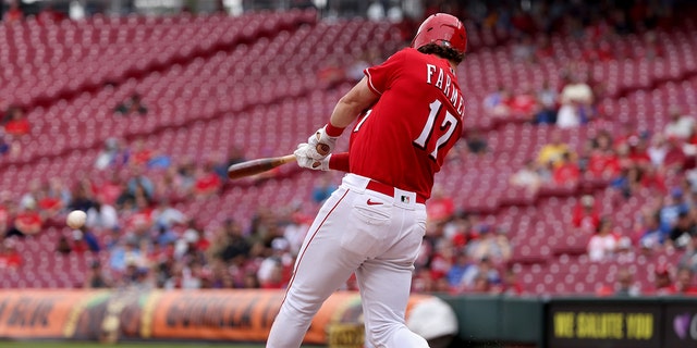 Kyle Farmer of the Cincinnati Reds hits a single in the sixth inning against the Chicago Cubs at Great American Ball Park May 26, 2022, in Cincinnati. 
