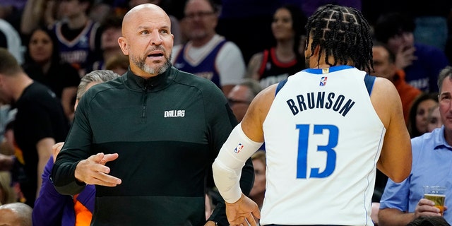 Dallas Mavericks head coach Jason Kidd, left, talks with Mavericks guard Jalen Brunson during the second half of Game 5 of an NBA basketball second-round playoff series against the Phoenix Suns Tuesday, May 10, 2022, in Phoenix.