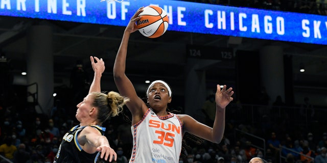 FILE - Connecticut Sun's Jonquel Jones (35) goes up for a shot against Chicago Sky's Courtney Vandersloot (22) and Candace Parker right, during the second half of Game 4 of a WNBA basketball playoff semifinal, Wednesday, Oct. 6, 2021, in Chicago.