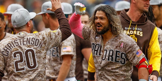 San Diego Padres' Jorge Alfaro, front right, celebrates with bench coach Ryan Christenson after hitting a three-run walkoff home run against the Miami Marlins during the ninth inning of a baseball game Sunday, May 8, 2022, in San Diego. 
