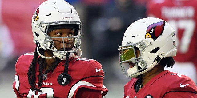 DeAndre Hopkins #10 and Kyler Murray #1 of the Arizona Cardinals prepare for the game against the Philadelphia Eagles at State Farm Stadium on Dec. 20, 2020 in Glendale, Arizona.