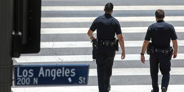 LOS ANGELES, CA - JUNE 21, 2021: Members of the LAPD make their way along Temple St. in  downtown Los Angeles. (Mel Melcon / Los Angeles Times via Getty Images)
