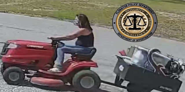 A woman riding an allegedly stolen lawnmower after stealing various from a home. 
