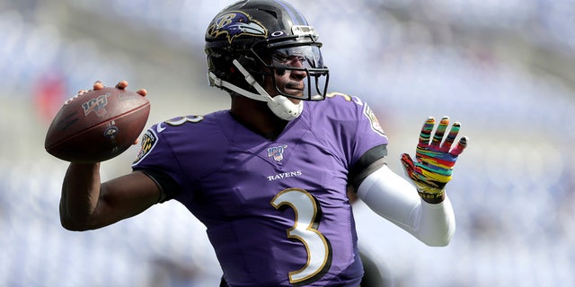 FILE - In this Oct. 13, 2019, file photo Baltimore Ravens quarterback Robert Griffin III works out prior to an NFL football game against the Cincinnati Bengals in Baltimore.