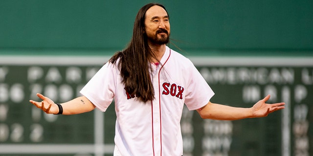 DJ Steve Aoki reacts after throwing out a ceremonial first pitch before the Red Sox-Houston Astros game on May 16, 2022, at Fenway Park in Boston, Massachusetts.