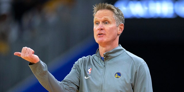 Golden State Warriors coach Steve Kerr signals to players during the first quarter of the team's NBA basketball game against the Philadelphia 76ers, Wednesday, Nov. 24, 2021, in San Francisco.